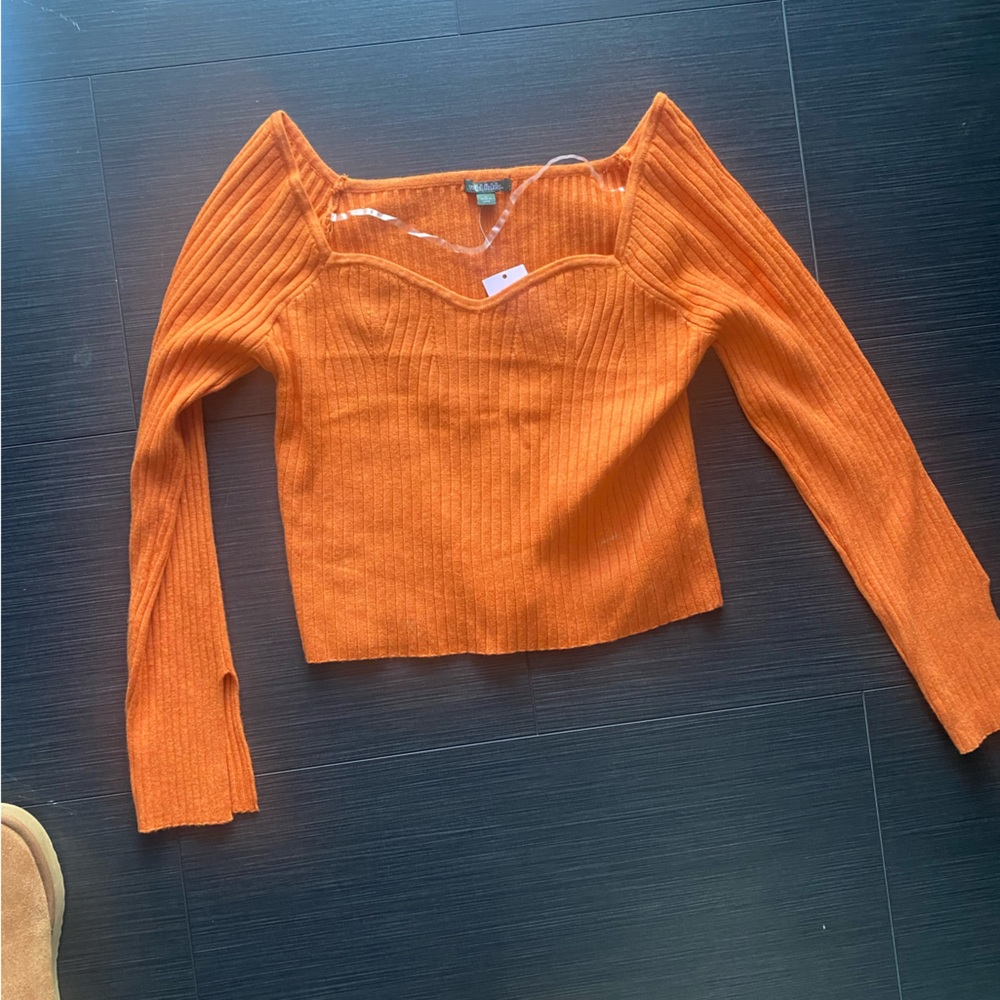 Long sleeve orange crop top. Never been worn.